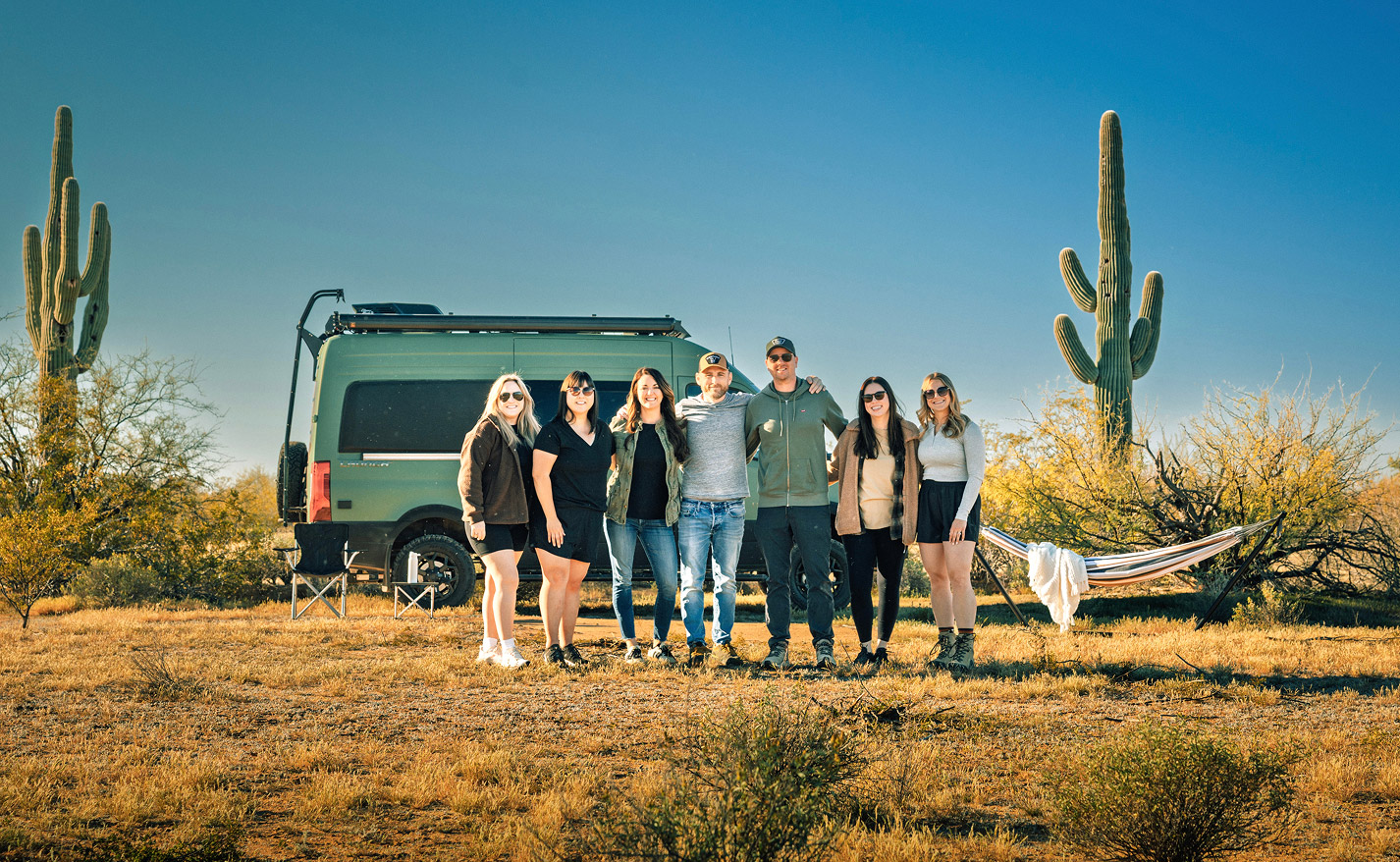 Kinetic Studios team posing in front of a van in a desert landscape